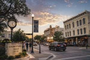 Things to do in Georgetown, Texas β the historic downtown square at sunset with the Palace Theatre marquee, limestone storefronts, and the Georgetown Texas welcome sign