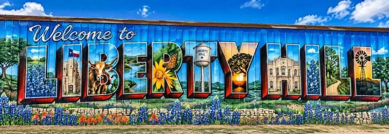 Welcome to Liberty Hill mural, a gateway to Liberty Hill master-planned communities, with bluebonnets, a longhorn and the water tower.